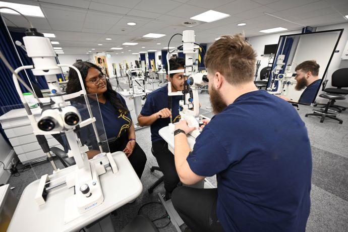 Student using optometry equipment 