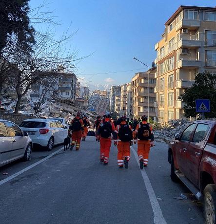 Medical workers walking up a damaged Turkish street