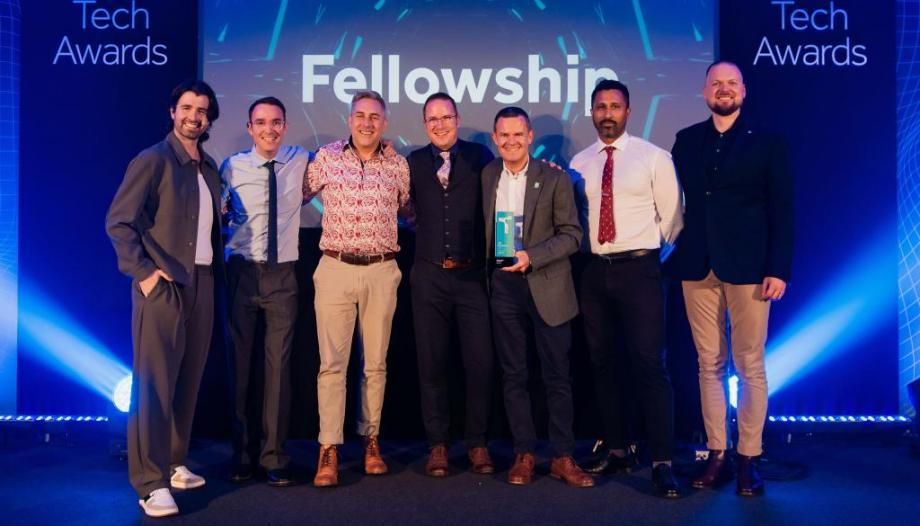 Fellowship team on stage receiving an award at the UK Business Tech Awards for digital agency of the year.