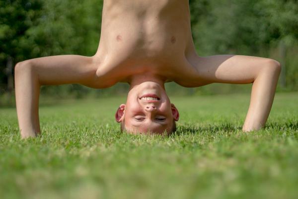 boy standing on his head in the park_ Image by Michal Jarmoluk from Pixabay