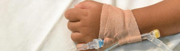 child's arm with cannula and tape_ Image credit:  Adobe Stock