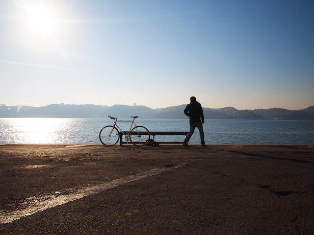 Person on a beach with bicycle
