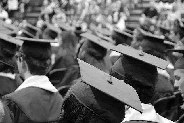Black and white photo of lots of graduation caps