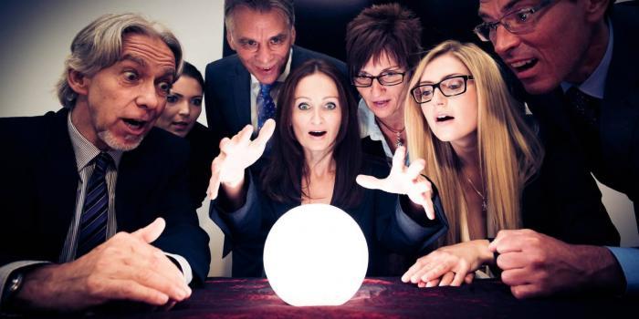 group looking at a crystal ball in astonishment