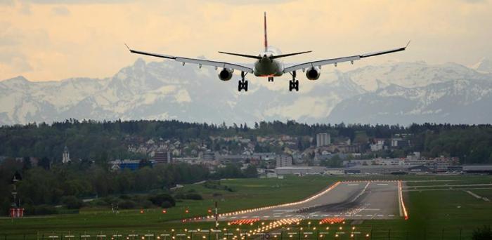   Plane landing in Zurich  Credit: Photo by Pascal Meier on Unsplash