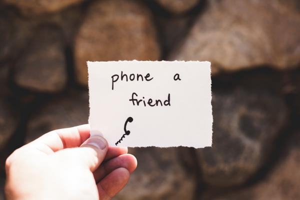 phone a friend - written on a note held in a hand