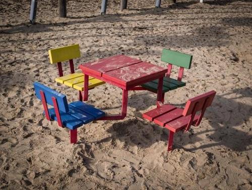 empty table and chairs on a sandy beach