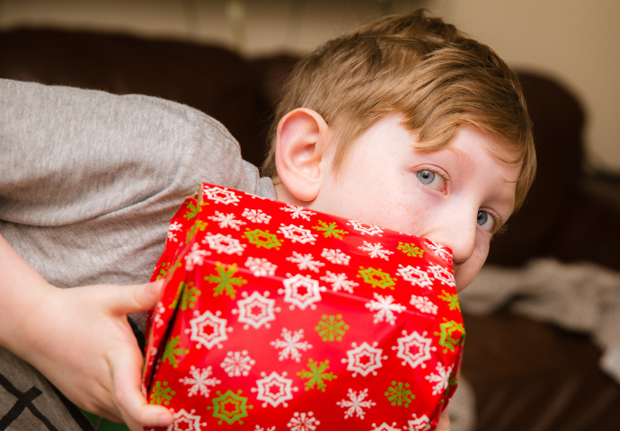 boy holding a Christmas gift 