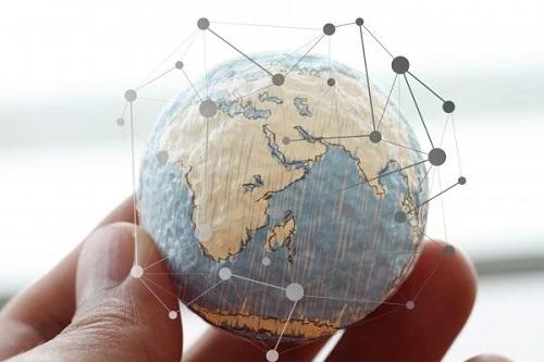  fingers hold globe with pinpoints