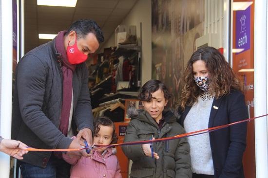 Keely Blows and Curtis Irish, son Teddy, nine, and daughter Marlowe, cutting a ribbon to mark both the grand opening of EACH's Royston shop and reopening of its 42 other shops across Cambridgeshire, Essex, Norfolk and Suffolk.