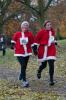 Women in red santa outfits running at the Arthur Rank Hospice Charity Festive 5K 