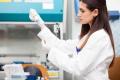 woman working in a laboratory_clinical trials insurance