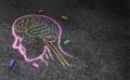 chalk drawing of a head with brain highlighted