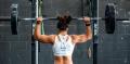   Woman lifting weights  Credit: John Arano on Unsplash