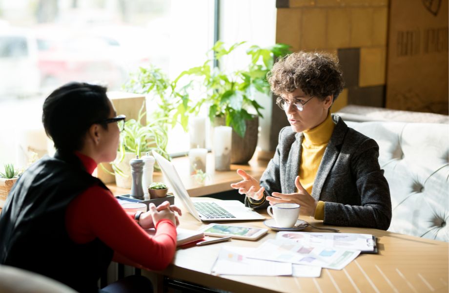 Two science marketing professionals discussing Account-Based Marketing strategies to boost B2B biotech sales and lead generation through data-driven insights.