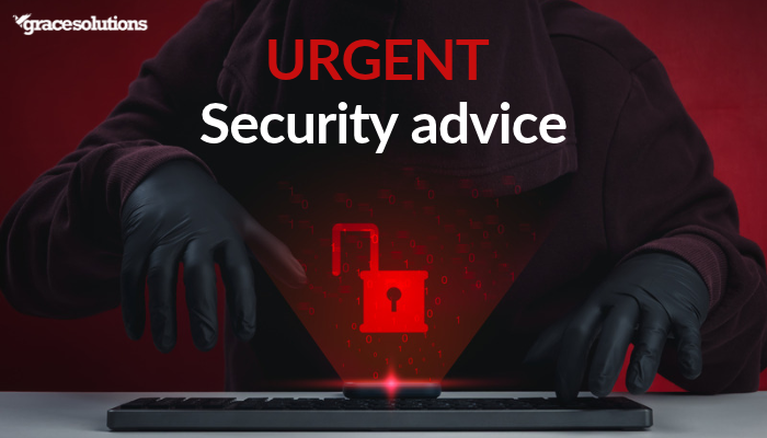 a dark figure looms over a laptop keyboard with a bright red padlock superimposed