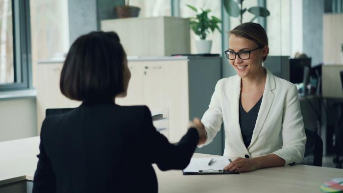 Business women shaking hands in an office